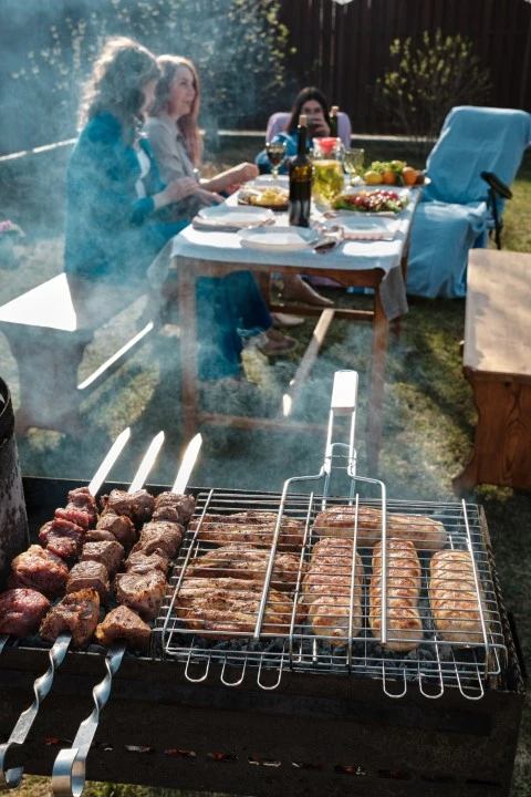 Ladokola skiathos catering barbecue kebab is being grilled background table family sits table (Small)