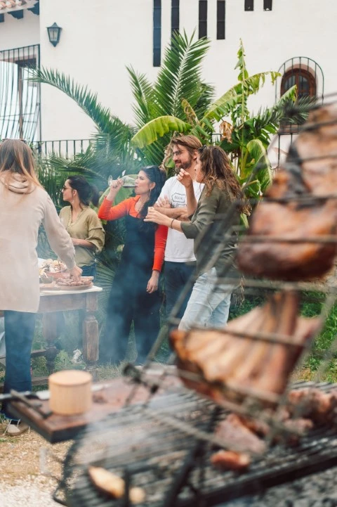 Ladokola skiathos catering group people are gathered around grill with bunch meat it (Small)